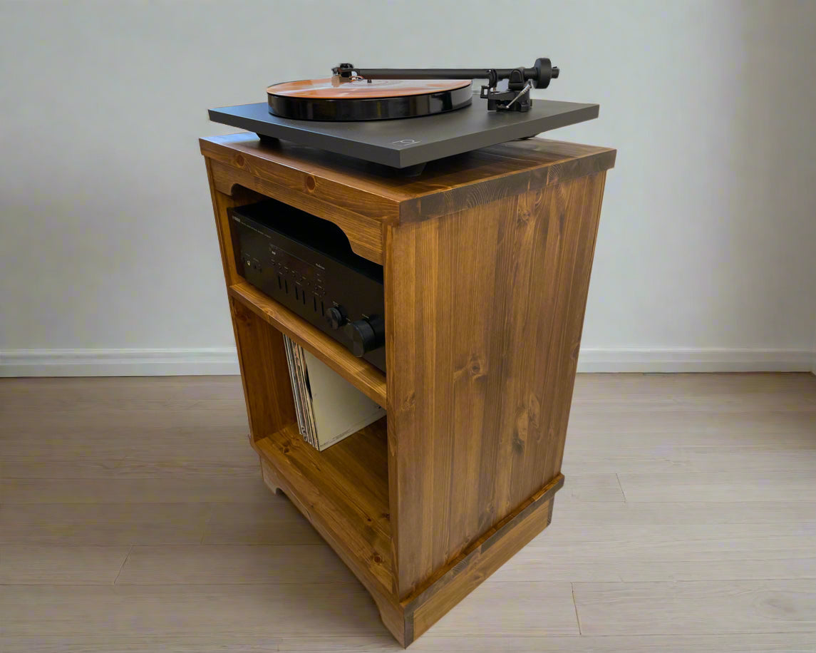 Wooden record player cabinet with turntable on a plain background